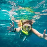 A woman snorkeling in the turquoise waters of the Red Sea.