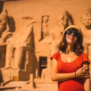 A tourist in front of Abu Simbel Temple in Aswan